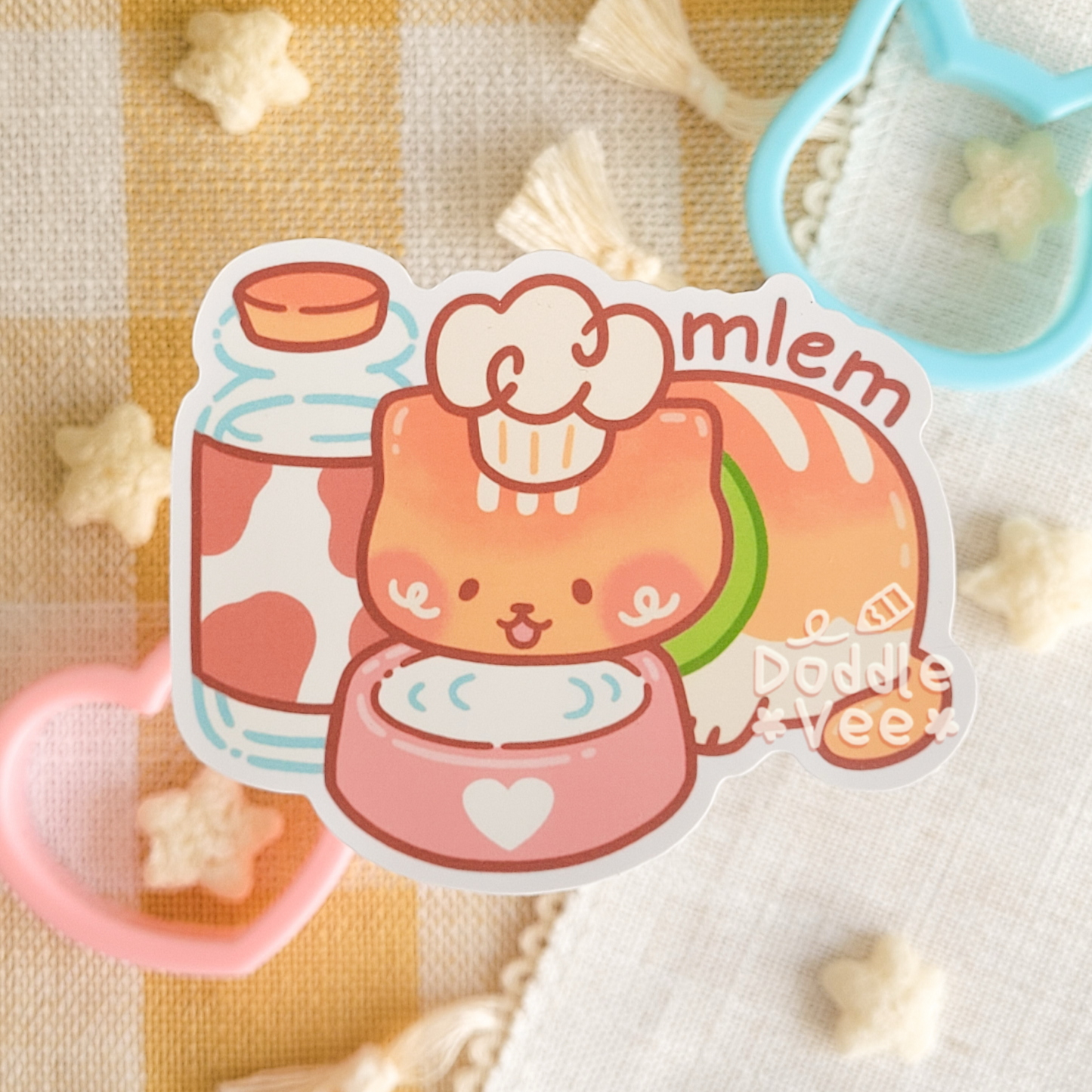 Sticker of Little Loaf or a cat drinking milk from a pink bowl with a jar of milk on the side. Words mlem appear above the cat.
