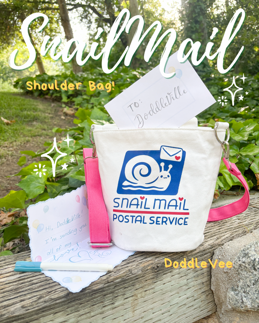 Snail Mail shoulder bag with a snail and envelope logo, placed outdoors on a wooden surface.