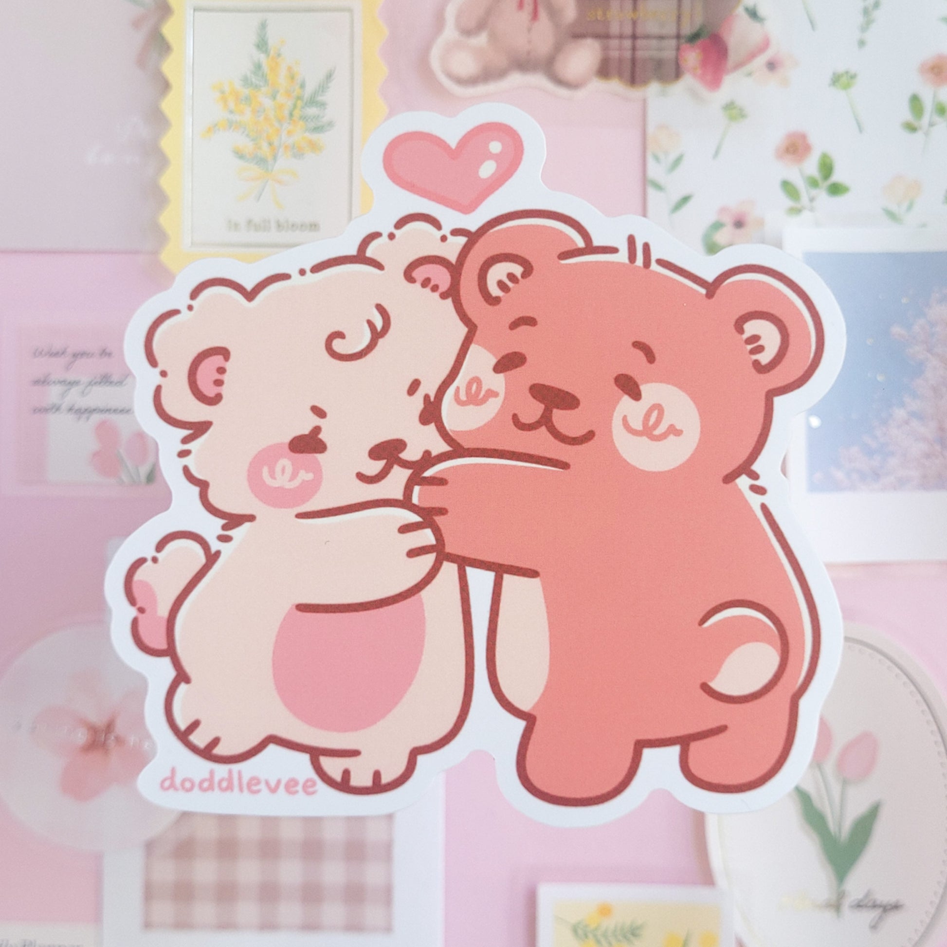 Sticker of pink and white bear hugging.