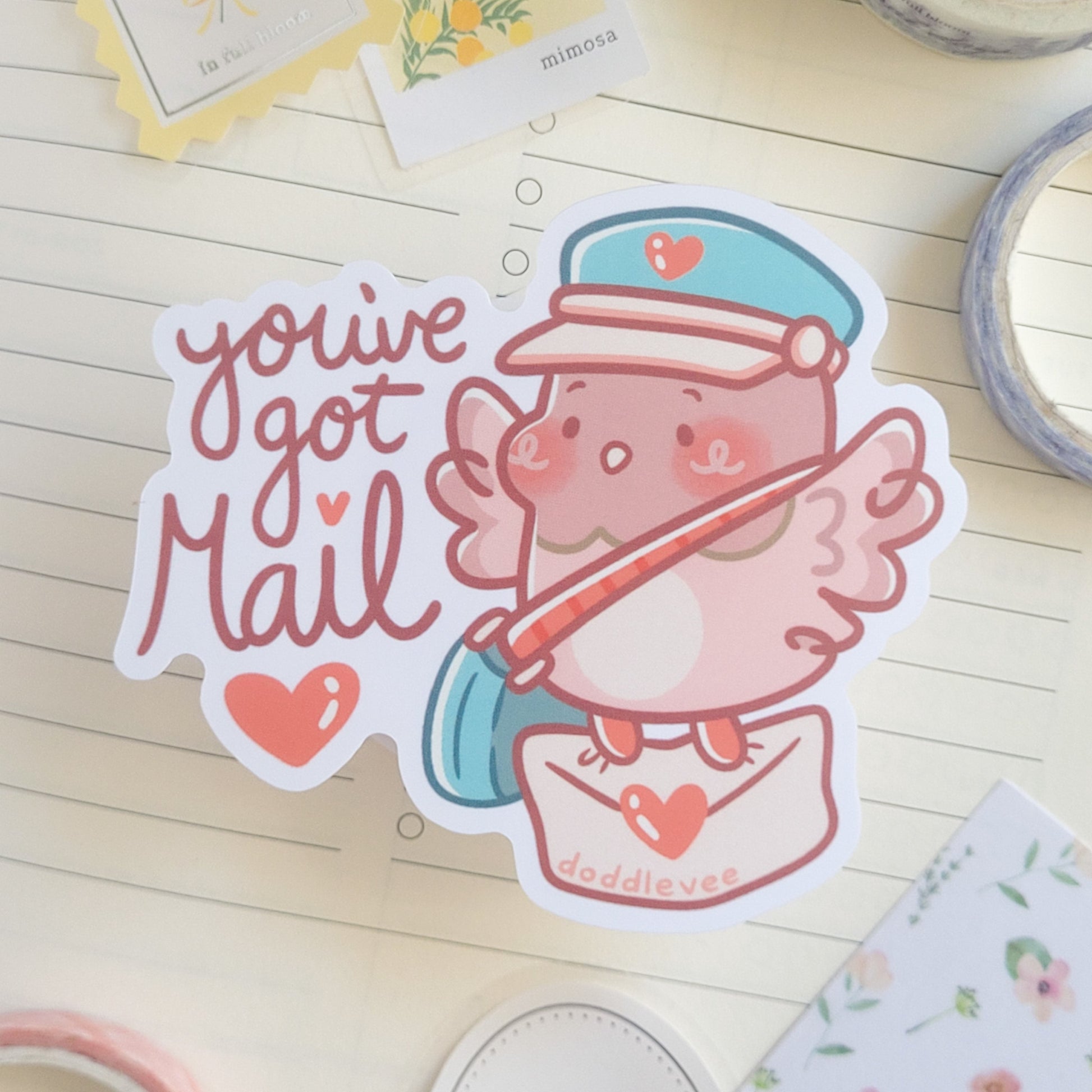 Sticker of pink pigeon holding a mail letter with the words you've got mail appearing on the sticker. 