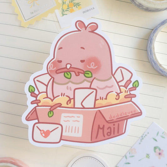 Sticker with a pigeon sitting in a box that says mail holding a stick in its mouth
