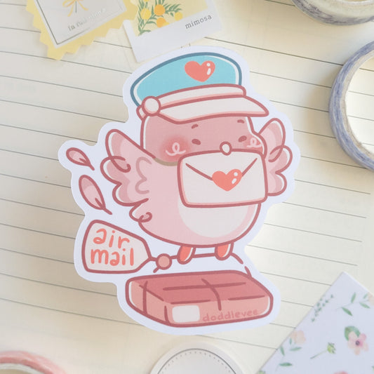 Sticker of pink pidgeon with a letter in its mouth carring a package that says air mail