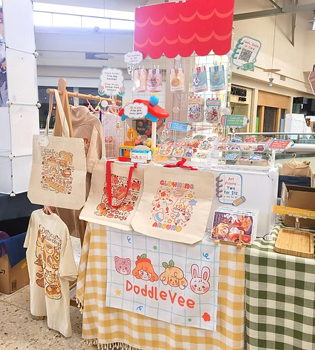Display of merchandise with 'DoddleVee' branding at a market stall.