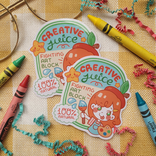 Sticker witht he words creative juce, fighting art block on it. Shows a orange haired girl holding a paint brush