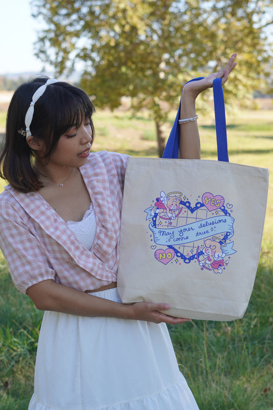 Woman holding a tote bag with decorative text and graphics outdoors