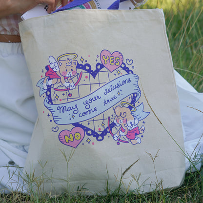 Beige tote bag with cartoon designs and text held by a person outdoors.