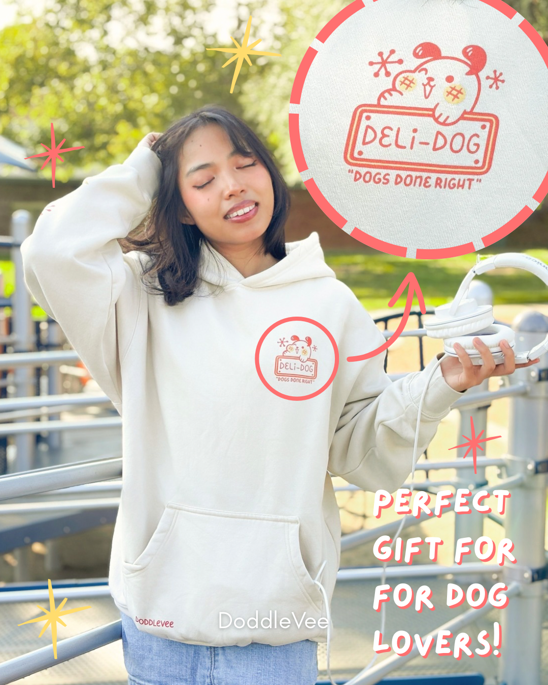 Person wearing a white hoodie with a brand logo, standing outdoors with a 'Deli-Dog' sign in the background.