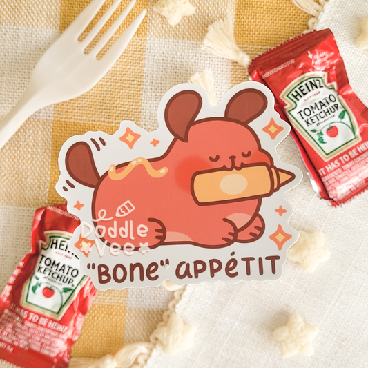 Sticker of a cartoon dog with a bone, surrounded by Heinz ketchup packets on a checkered tablecloth.