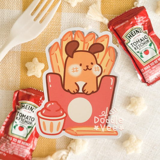 Sticker of a cartoon character on a bag of fries with Heinz ketchup packets and popcorn on a checkered tablecloth.