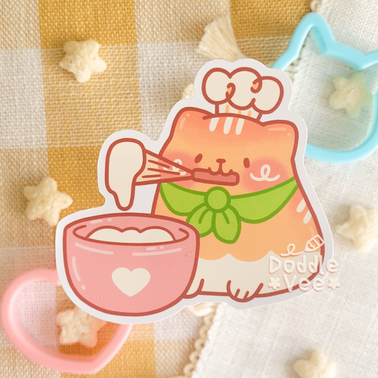 Sticker of a cute cat character making tea on a checkered fabric background