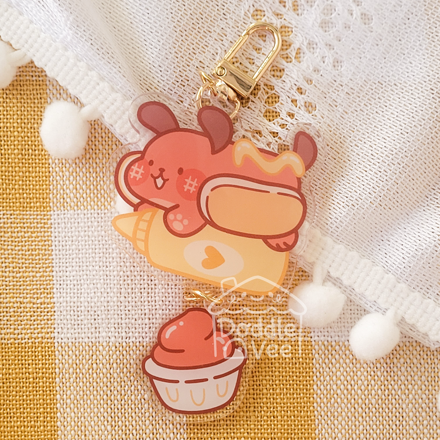 Link keychain of a hotdog riding a ketchup bottle. Second keychain is a ketchup 