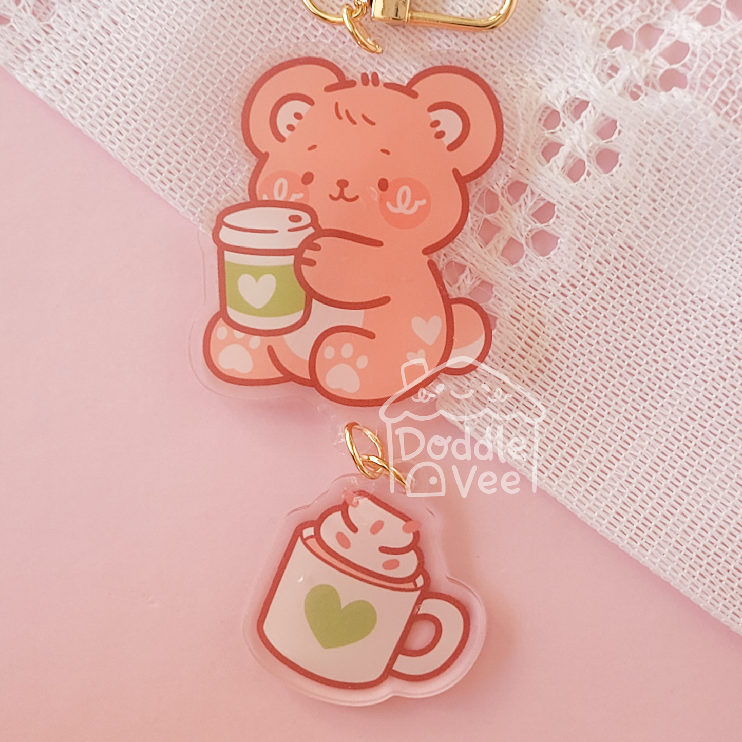 Cute bear charm with a cup on a pink background