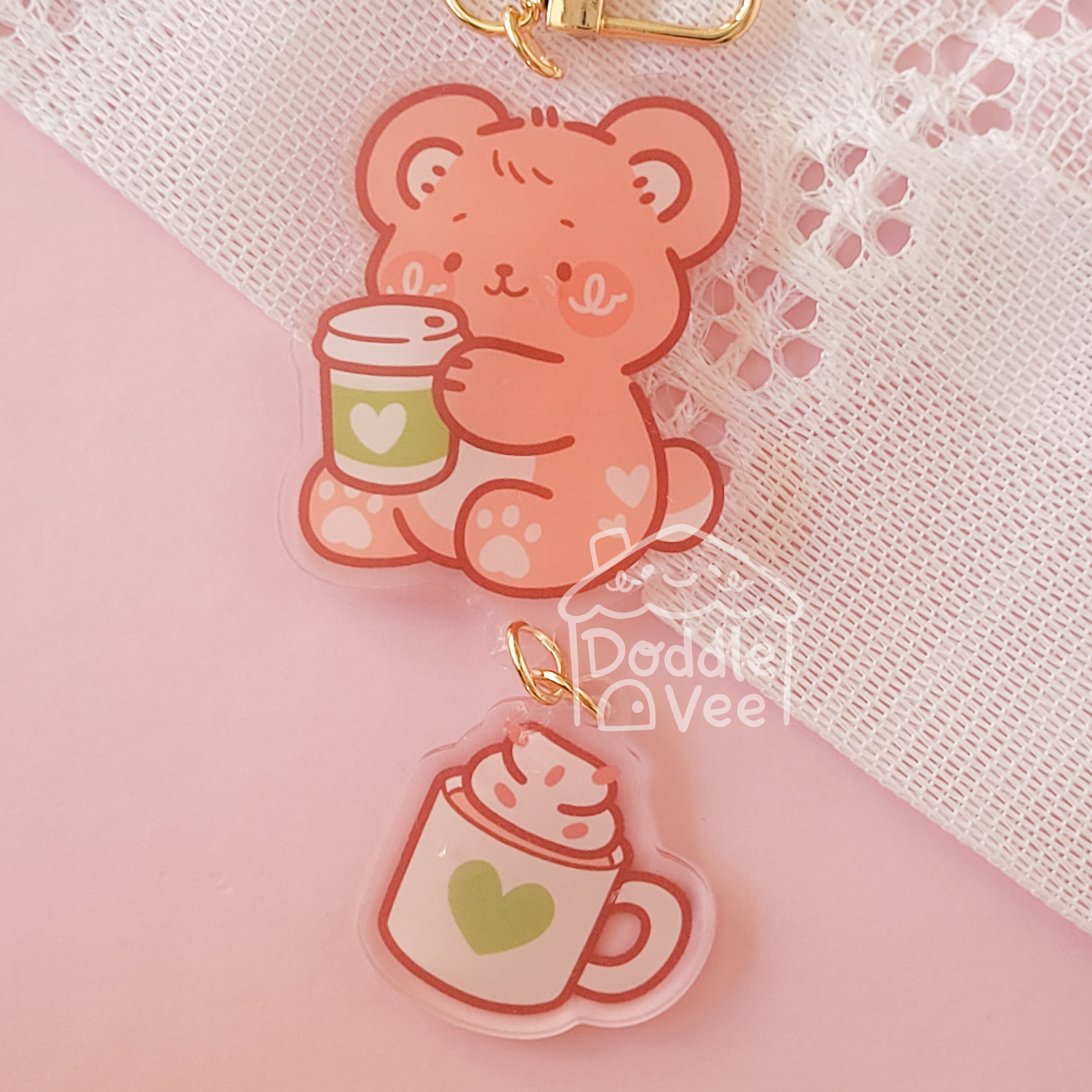 Cute bear charm with a cup on a pink background