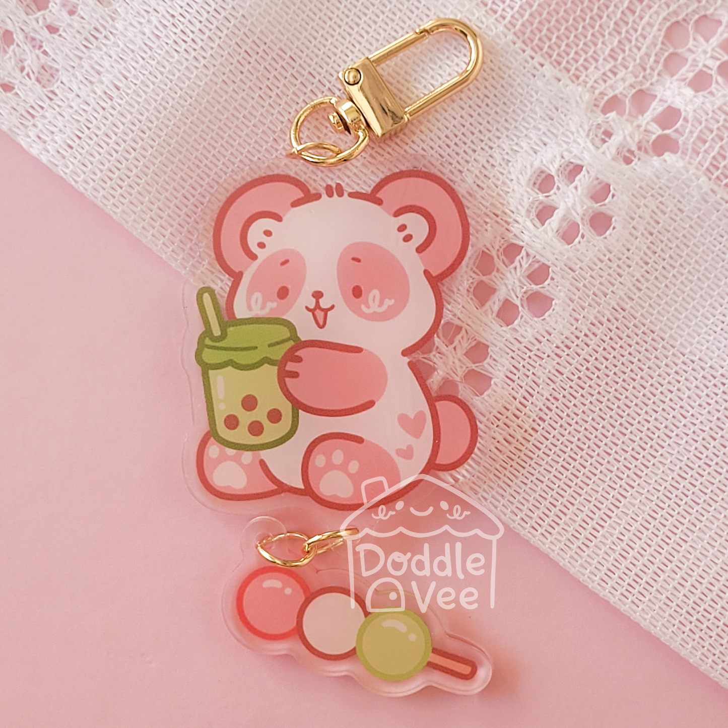 Link keychain of pink panda holding green boba. Second link keychain is dango
