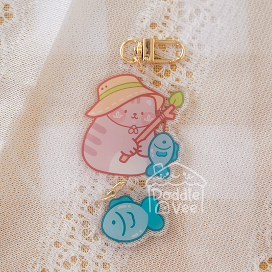 Link keychain of tabby cat fishing and other link is a fish