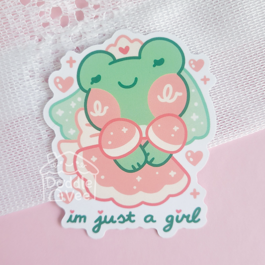Sticker of a green character with a pink bow and 'I'm just a girl' text on a pink background
