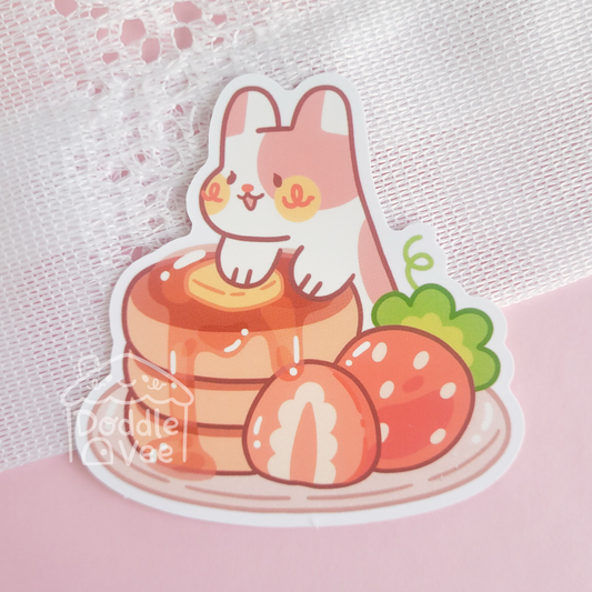 Cartoon rabbit character on a cake with strawberries on a pink background
