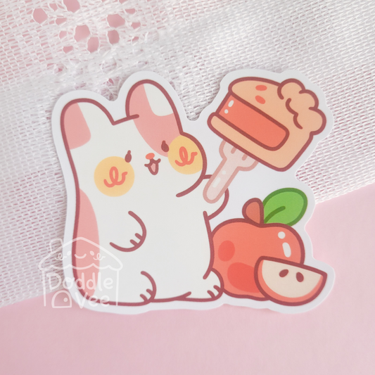Cartoon cat holding a cupcake with an apple on a pink background