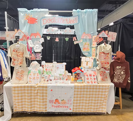Stall with merchandise and branding for 'Doddle Wee' at a convention.