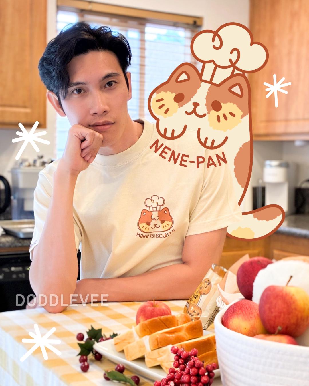 Person wearing a t-shirt with a cartoon character design in a kitchen setting